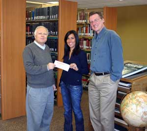 PHOTO: Talita Thomaz receives her scholarship check