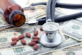 Pills and stethoscope on dollars
